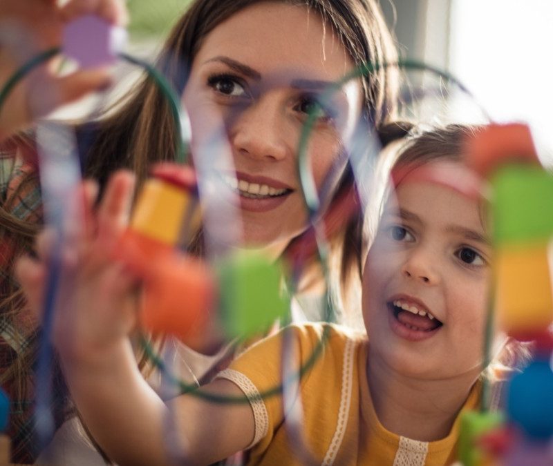 Early intervention specialist or therapist working with toddler or young child with autism